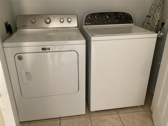 2305 Butterfly Palm Way Unit 304, Kissimmee, FL 34747 - washroom featuring washer and clothes dryer and light tile patterned floors