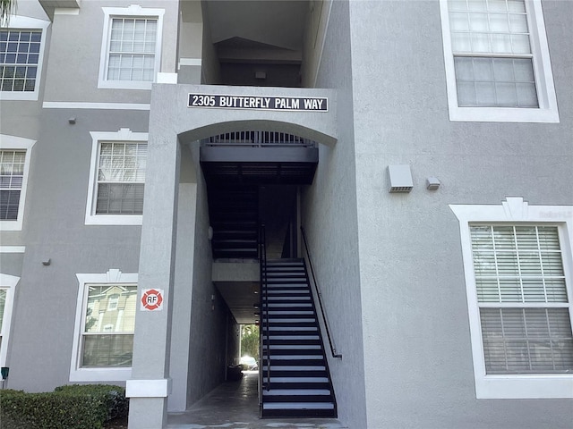 2305 Butterfly Palm Way Unit 304, Kissimmee, FL 34747 - property entrance with stucco siding