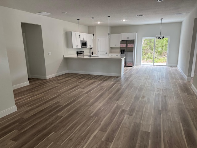 706 Marion Oaks Mnr, Ocala, FL 34473 - kitchen featuring appliances with stainless steel finishes, open floor plan, light countertops, a peninsula, and recessed lighting