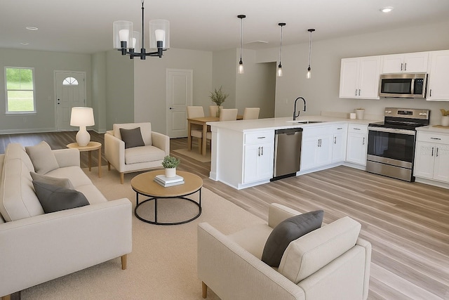 706 Marion Oaks Mnr, Ocala, FL 34473 - living area featuring light wood-type flooring, recessed lighting, a chandelier, and baseboards