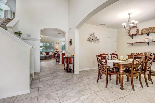 998 Sorrel St NW, Palm Bay, FL 32907 - dining space featuring arched walkways, a chandelier, baseboards, and stairs