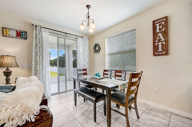 998 Sorrel St NW, Palm Bay, FL 32907 - dining area featuring healthy amount of natural light, light tile patterned floors, baseboards, and a textured ceiling