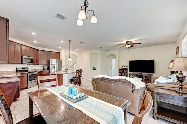 998 Sorrel St NW, Palm Bay, FL 32907 - dining area featuring arched walkways, a ceiling fan, recessed lighting, and light tile patterned floors