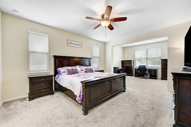 998 Sorrel St NW, Palm Bay, FL 32907 - bedroom with light colored carpet, a desk, a textured ceiling, ceiling fan, and baseboards