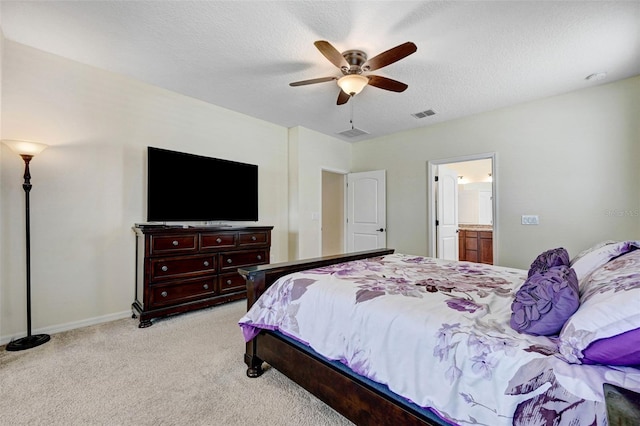 998 Sorrel St NW, Palm Bay, FL 32907 - bedroom featuring light carpet, ensuite bath, a ceiling fan, baseboards, and a textured ceiling