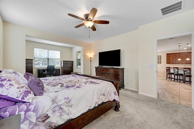 998 Sorrel St NW, Palm Bay, FL 32907 - bedroom featuring a desk, light colored carpet, baseboards, and a ceiling fan