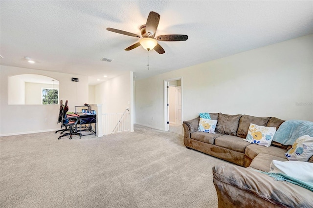 998 Sorrel St NW, Palm Bay, FL 32907 - carpeted living room with ceiling fan, baseboards, and a textured ceiling