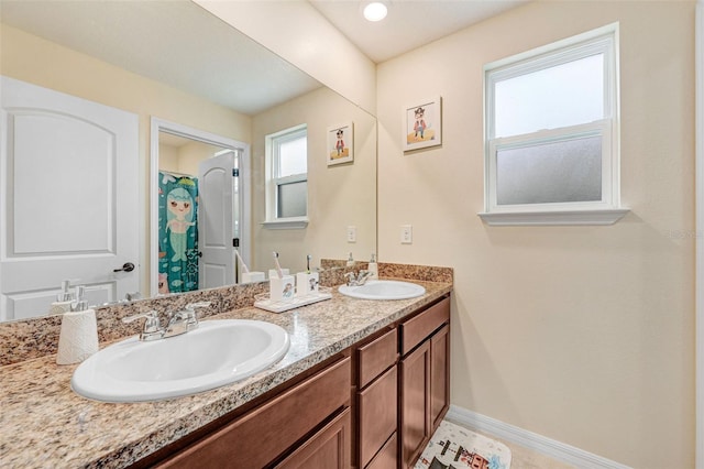 998 Sorrel St NW, Palm Bay, FL 32907 - bathroom with double vanity, baseboards, and a shower with curtain