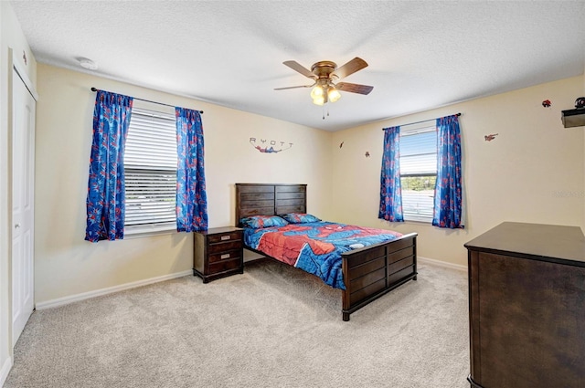 998 Sorrel St NW, Palm Bay, FL 32907 - bedroom with light carpet, baseboards, ceiling fan, and a textured ceiling