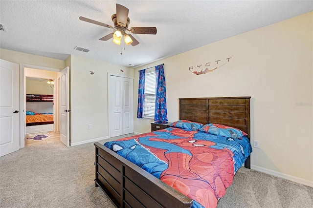 998 Sorrel St NW, Palm Bay, FL 32907 - carpeted bedroom with baseboards, ceiling fan, a textured ceiling, and a closet