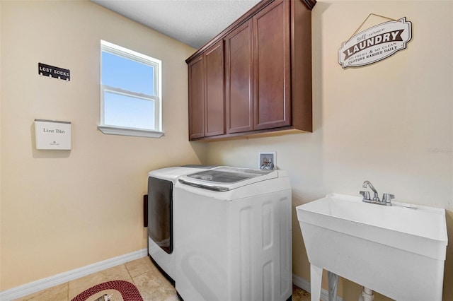 998 Sorrel St NW, Palm Bay, FL 32907 - laundry room with cabinet space, washer and clothes dryer, baseboards, and light tile patterned floors