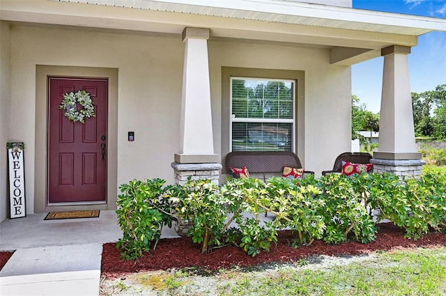 998 Sorrel St NW, Palm Bay, FL 32907 - property entrance with covered porch and stucco siding