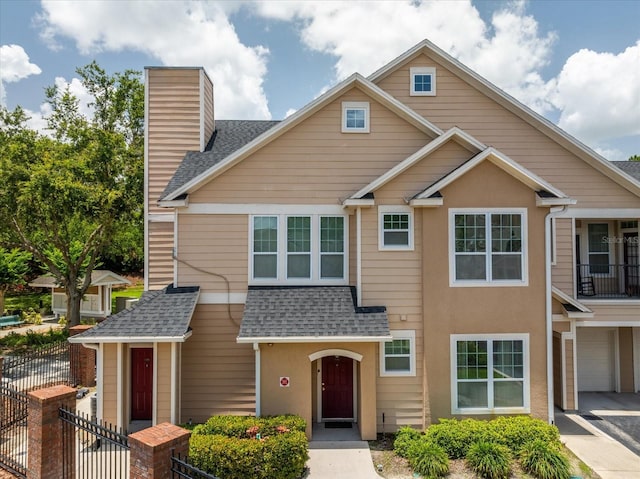 1101 Vintage Village Ln Unit 101, Ocoee, FL 34761 - multi unit property featuring a shingled roof, a chimney, driveway, and an attached garage