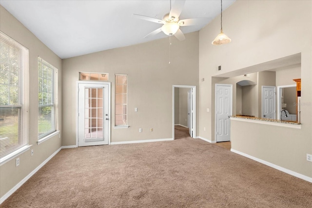1101 Vintage Village Ln Unit 101, Ocoee, FL 34761 - unfurnished living room featuring a ceiling fan, carpet floors, and high vaulted ceiling