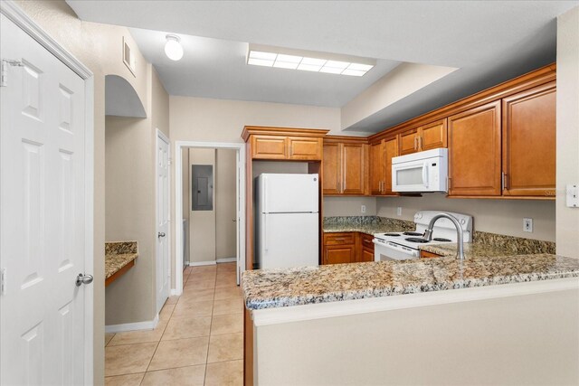 1101 Vintage Village Ln Unit 101, Ocoee, FL 34761 - kitchen with white appliances, electric panel, light stone counters, and brown cabinets