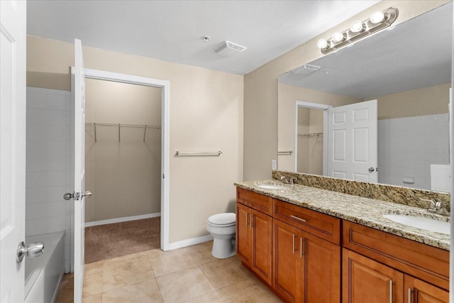 1101 Vintage Village Ln Unit 101, Ocoee, FL 34761 - bathroom featuring double vanity, a walk in closet, and tile patterned flooring