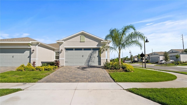 1650 Key Bay Trl, Kissimmee, FL 34747 - ranch-style home with driveway, stucco siding, an attached garage, a residential view, and a front lawn