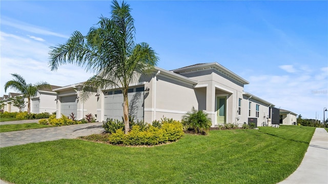 1650 Key Bay Trl, Kissimmee, FL 34747 - view of home's exterior featuring a lawn, a garage, stucco siding, and driveway