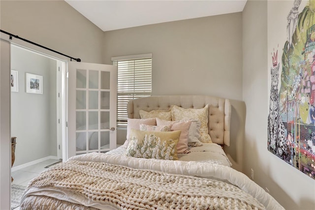 1650 Key Bay Trl, Kissimmee, FL 34747 - bedroom with tile patterned flooring, a barn door, and baseboards