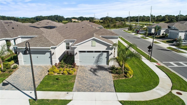 1650 Key Bay Trl, Kissimmee, FL 34747 - view of front of home featuring an attached garage, driveway, and stucco siding