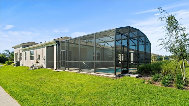 1650 Key Bay Trl, Kissimmee, FL 34747 - back of house featuring an outdoor pool, a yard, cooling unit, and stucco siding