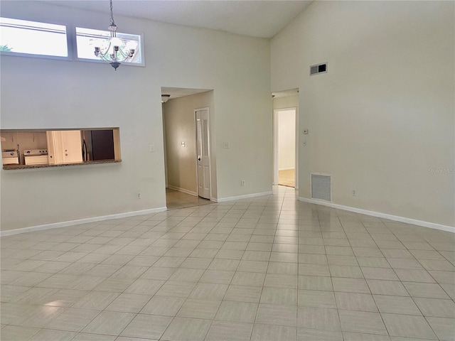 1110 Woodbine St, Fern Park, FL 32730 - unfurnished living room featuring a towering ceiling, a chandelier, and baseboards