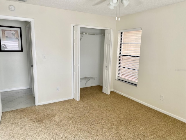1110 Woodbine St, Fern Park, FL 32730 - unfurnished bedroom featuring light colored carpet, a closet, baseboards, a textured ceiling, and a ceiling fan