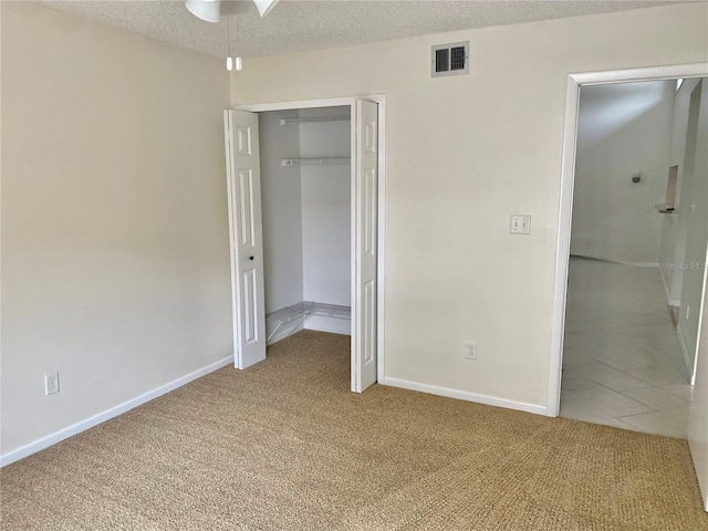 1110 Woodbine St, Fern Park, FL 32730 - unfurnished bedroom featuring carpet, a closet, baseboards, and a textured ceiling