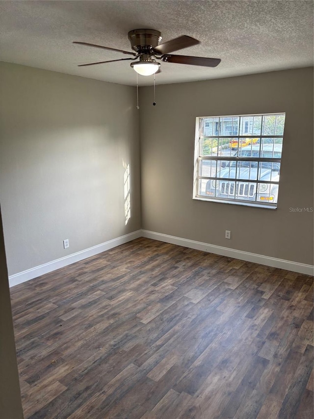 2085 San Jose Blvd, Orlando, FL 32808 - spare room featuring dark wood-style floors, a textured ceiling, a ceiling fan, and baseboards