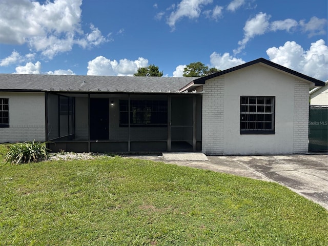 2085 San Jose Blvd, Orlando, FL 32808 - ranch-style home featuring brick siding and a front yard