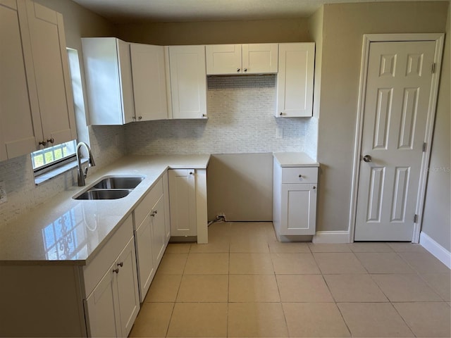 2085 San Jose Blvd, Orlando, FL 32808 - kitchen with white cabinets, light tile patterned floors, and tasteful backsplash
