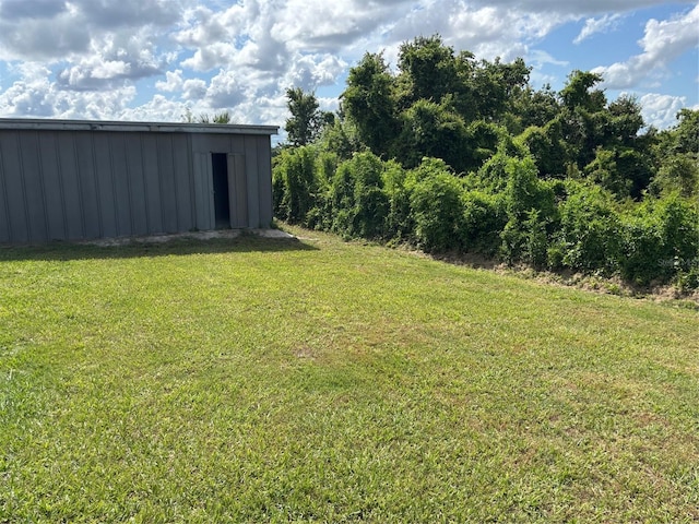 2085 San Jose Blvd, Orlando, FL 32808 - view of grassy yard featuring an outbuilding and an outdoor structure