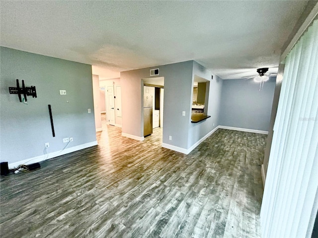 9918 Turf Way Unit 5, Orlando, FL 32837 - unfurnished living room featuring a textured ceiling, wood finished floors, ceiling fan, and baseboards