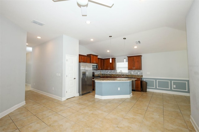 1061 Citrus Landings Blvd, Davenport, FL 33837 - kitchen with stainless steel appliances, lofted ceiling, a kitchen island, ceiling fan, and pendant lighting