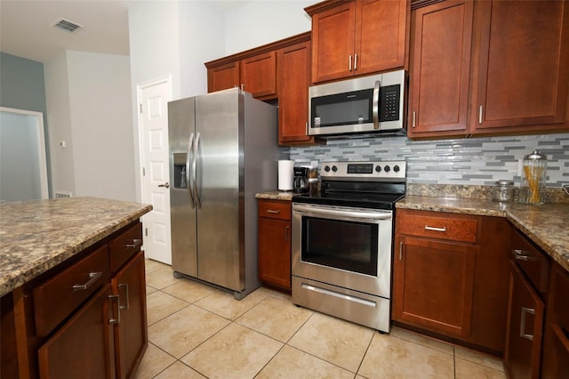 1061 Citrus Landings Blvd, Davenport, FL 33837 - kitchen with stainless steel appliances, backsplash, and light tile patterned floors