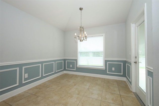 1061 Citrus Landings Blvd, Davenport, FL 33837 - unfurnished dining area with a chandelier, lofted ceiling, a wainscoted wall, and light tile patterned floors