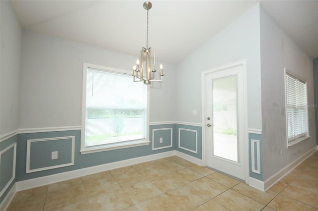 1061 Citrus Landings Blvd, Davenport, FL 33837 - unfurnished dining area featuring vaulted ceiling, a chandelier, light tile patterned floors, and a wainscoted wall