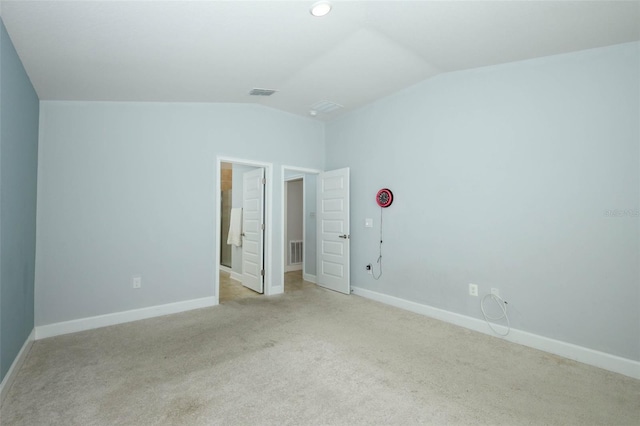 1061 Citrus Landings Blvd, Davenport, FL 33837 - unfurnished bedroom featuring vaulted ceiling, light colored carpet, and baseboards