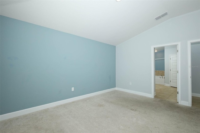 1061 Citrus Landings Blvd, Davenport, FL 33837 - unfurnished bedroom with lofted ceiling, carpet, and baseboards