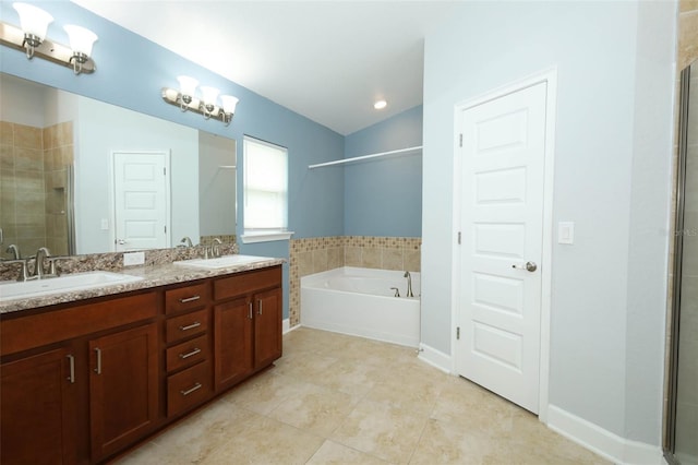 1061 Citrus Landings Blvd, Davenport, FL 33837 - full bath with a shower stall, a garden tub, double vanity, tile patterned flooring, and baseboards