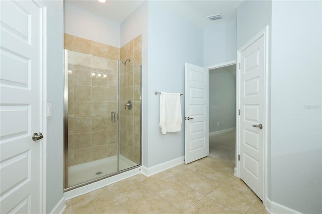 1061 Citrus Landings Blvd, Davenport, FL 33837 - bathroom featuring a shower stall, tile patterned flooring, and baseboards