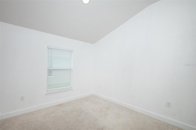 1061 Citrus Landings Blvd, Davenport, FL 33837 - carpeted empty room featuring vaulted ceiling and baseboards