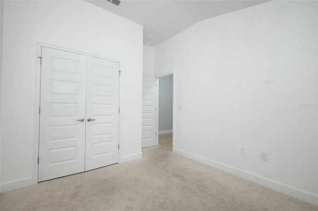 1061 Citrus Landings Blvd, Davenport, FL 33837 - unfurnished bedroom featuring lofted ceiling, carpet flooring, baseboards, and a closet