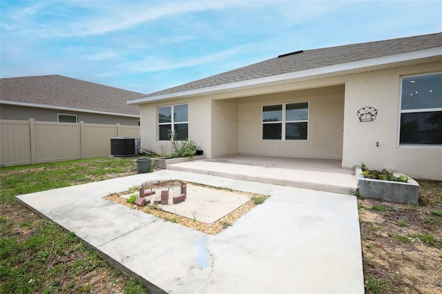 1061 Citrus Landings Blvd, Davenport, FL 33837 - back of house with a patio area, central AC, stucco siding, and roof with shingles