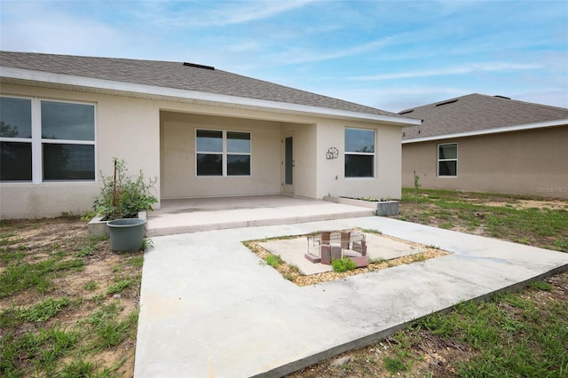 1061 Citrus Landings Blvd, Davenport, FL 33837 - back of house with a patio, stucco siding, and a shingled roof