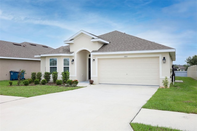 1061 Citrus Landings Blvd, Davenport, FL 33837 - single story home featuring stucco siding, roof with shingles, concrete driveway, a front yard, and a garage