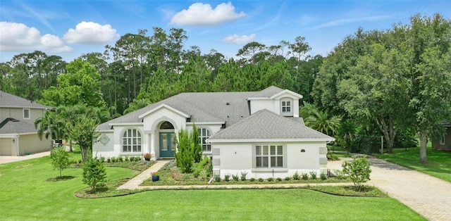 2908 Lee Shore Loop, Orlando, FL 32820 - view of front of house featuring stucco siding, a front lawn, roof with shingles, driveway, and french doors