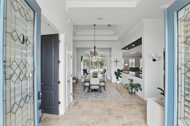 2908 Lee Shore Loop, Orlando, FL 32820 - foyer entrance with a raised ceiling, a chandelier, ornamental molding, light stone finish floors, and baseboards