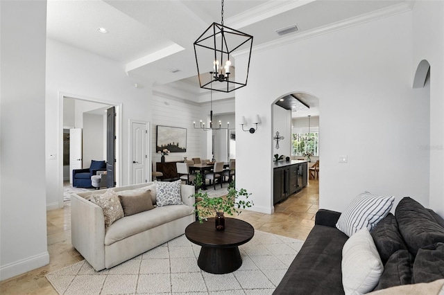 2908 Lee Shore Loop, Orlando, FL 32820 - living room with arched walkways, a chandelier, baseboards, a high ceiling, and crown molding