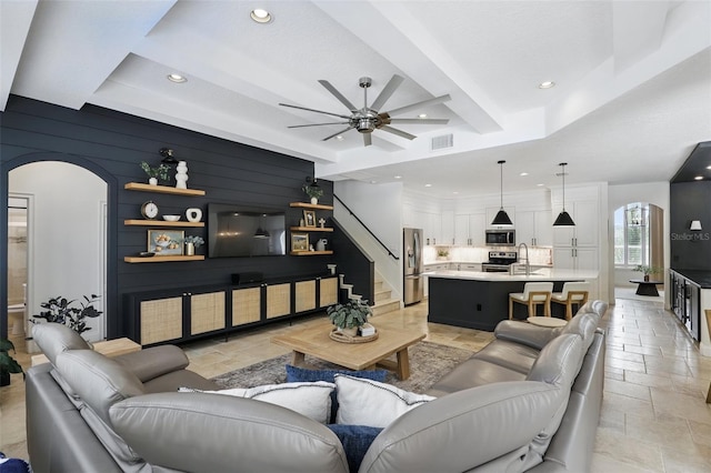 2908 Lee Shore Loop, Orlando, FL 32820 - living area with stone tile floors, arched walkways, recessed lighting, a ceiling fan, and stairs